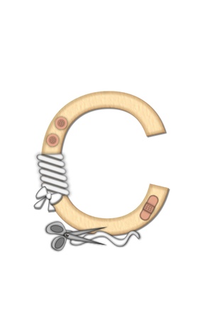 Alphabet letter C, in the alphabet set Boo Boo, is decorated with gauze bandages and band aids.  A pair of scissors and extra gauze sits at bottom of letter.の写真素材
