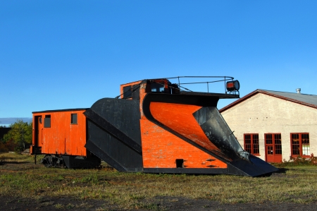 Vintage railroad car sits besides abandoned railroad track in Upper Penninsula, Michigan.  Railroad car has front-mounted plow for snow removal on tracks.のeditorial素材