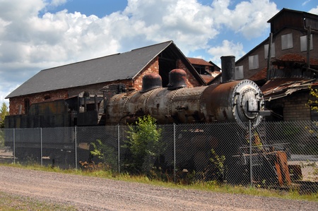 Old Northern Pacific Steam Locomotive sits inside the fence at the Quincy Copper Smelter in Hancock,...
