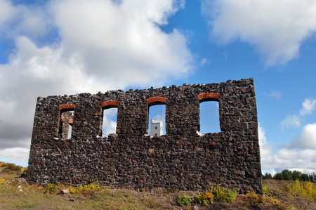 Cumbling window, of Boiler House Number 4, frames the Shaft Rock House of the Quincy Copper Mine in the Keweenaw National Historical Park near Hancock, Michigan.のeditorial素材