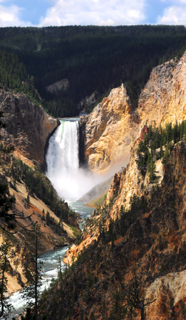 Landscape image shows Lower Falls and the Yellowstone River in Yellowstone National Park.  Steep canyon walls are tinyellow and orange.の写真素材