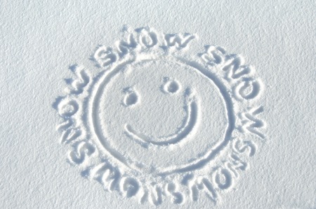 Handrawn "smiley face" is surrounded by the words "snow."  All are drawn on a fresh layer of Colorado snow.の写真素材