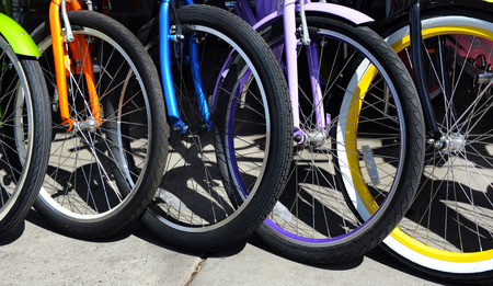 Background image shows a group of colorful bicycles.  Bikes are for rent in Bozeman, Montana.