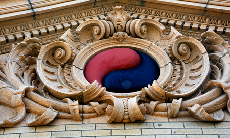 Unusual symbol decorates the exterior of the old Livingston train depot in Montana.  The red and black yin-yang symbol is red and black.の写真素材