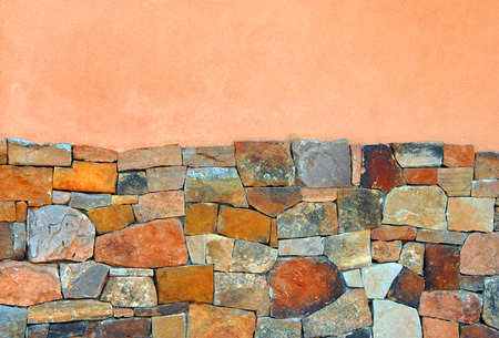 Background image  stone wall. Top half is pink  bottom irregular shaped stones.の写真素材