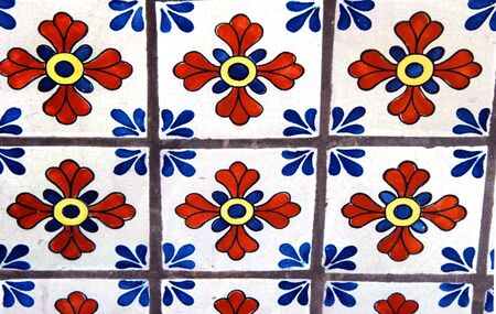 Background image show old tile floor with mosaic pattern of flowers and fourishes.の写真素材