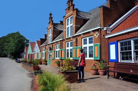 Shops line the street in Dutch Windmill Island in Holland, Michigan.  Store fronts are styled like a...
