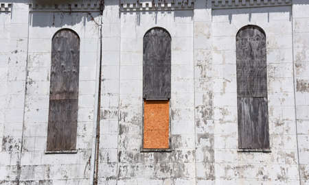 Three arched windows are closed off with plywood on the Brick Church in Memphis, Tennessee. ...