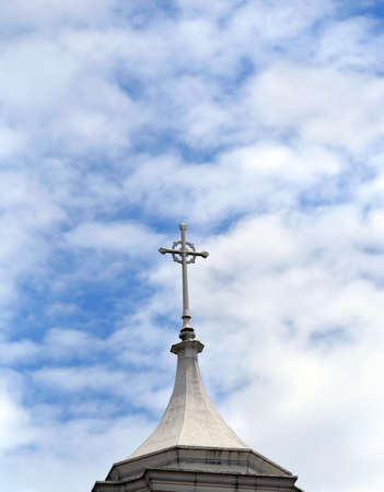Cross tops the Second Presbyterian Church in Memphis, Tennessee.  Blue sky and fluffy clouds fill background.の写真素材