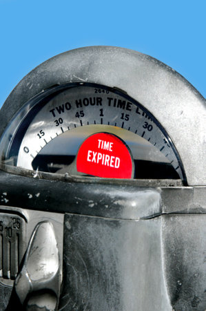 Chrome colored parking meter shows red time expired sign.  Coin slots are below.の写真素材