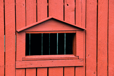 Closeup shows a window on the Bible Covered Bridge in North Carolina.  Structure is wooden and painted red.の写真素材