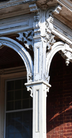 Old, historic building in Jonesborough, Tennessee, has an elegant corner post with intricate wooden carvings.の写真素材