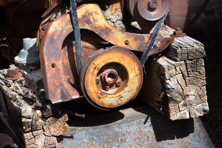 Belt driven, steel mining equipment is rusting and wood is rotting.  Equipment is from the mining...