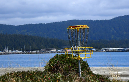 Disc Golf basket sits in the beach front park, in Crescent City, California, known as Howe Drive Park.の写真素材