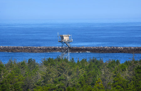 Fire tower stands high above the trees along the coast of Oregon.  It has an unobstructed view.の写真素材