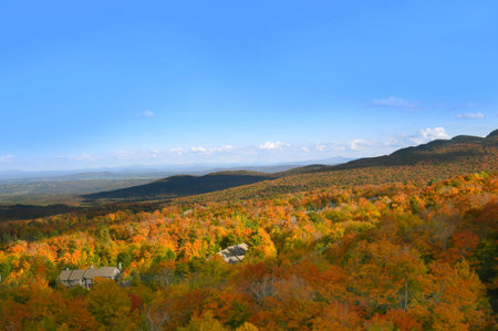 Autumn orange covers Jay Peak Resort and Jay Peak in the Green Mountains of Vermont. High angle photo is taken from ski lift as evening shadows are falling.の写真素材