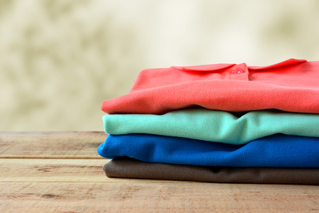 Stack of polo shirt on wooden.の写真素材