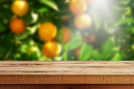 Wooden empty and blur orange garden background.