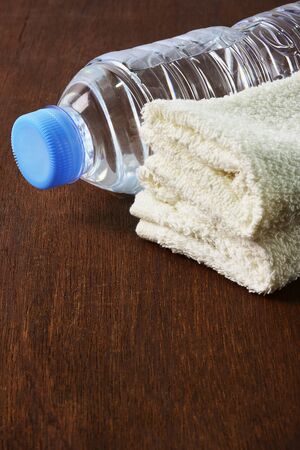 Bottle of water and towel on wooden.の写真素材