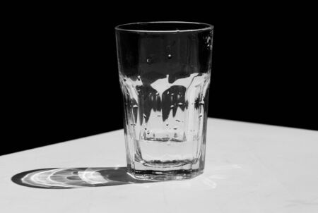 A black and white photo of a tumbler on the tableの写真素材