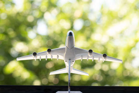 White plane on a background of green foliage. Green backgroundの写真素材