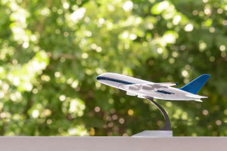 White plane on a background of green foliage. Green backgroundの写真素材