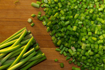 Green garlic on wooden cutting boardの写真素材