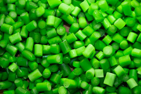 Cutting green garlic. Green backgroundの写真素材