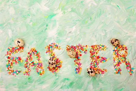 Easter text on a green background with brush strokes with quail eggs. Spring card. Copy spaceの写真素材
