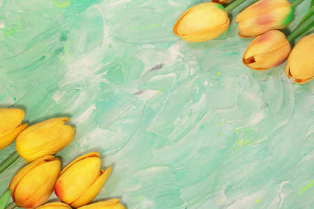 Yellow tulips from the corners. flower layout. Greeting card with Easter, March 8, happy birthday, mother's day. Copy spaceの写真素材