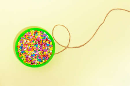 Balloon with sweets confetti on a string. Copy spaceの写真素材
