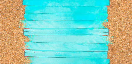 Marine banner. Turquoise horizontal wooden jetty planks with beach pebble sand. Travel and tourism....