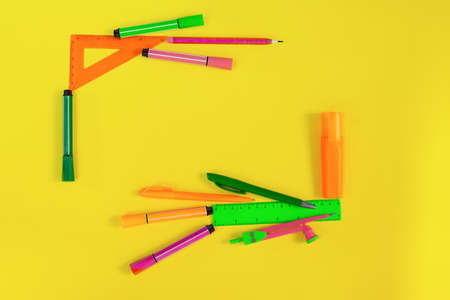 Back to school. Frame made of stationery. Rulers, markers, markers, pens, compasses. Place for text. Learning concept. Copy spaceの写真素材