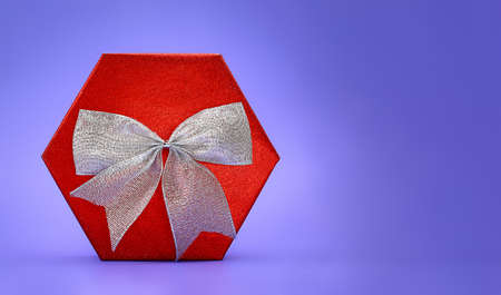 Big shiny red box with silver bow on lilac background. Present. Christmas, New Year, Mother's, Father's, International Women's Day, March 8, Birthday, Valentine. Copy spaceの写真素材