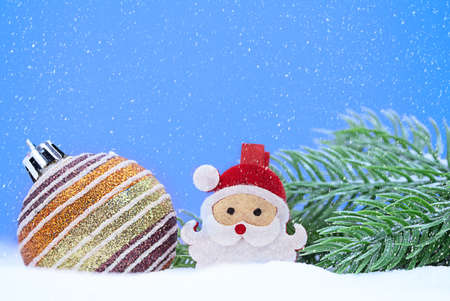 Christmas shiny striped ball with Santa Claus spruce branches on snow. Snowing. New Year. Copy spaceの写真素材