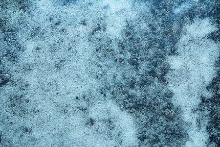 Blue frozen water, icy window, frost, texture. Winter. Background. Copy spaceの写真素材