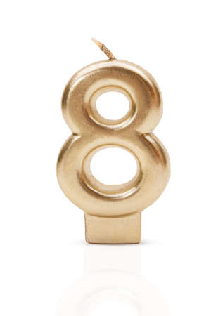 Gold number 8. Candle on white isolated background. International Women's Day, Birthday,...