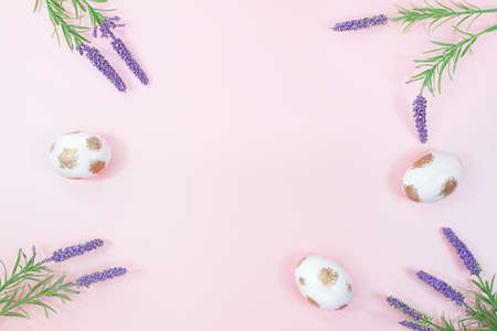Painted white eggs with gold and lavender, sage flowers on pink background. happy easter. copy spaceの写真素材