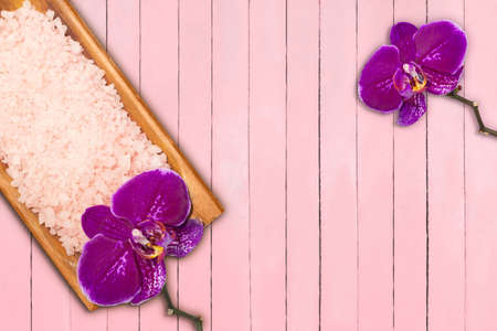Sea salt with shell in bowl with purple orchids on pink boards. spa conceptの写真素材