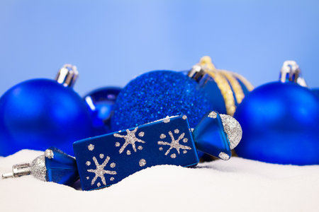 Blue Christmas balls, candy on snow with blurred background. Christmas, New Year. copy spaceの写真素材