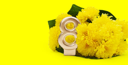 Bouquet of yellow chrysanthemums with golden number 8 with space for text. International Women's Day, March 8, birthday. copy spaceの写真素材