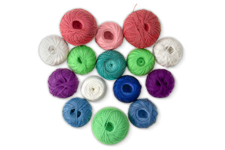Multi-colored wool balls, yarn in shape of heart on white isolated background. Concept of knitting, sewing, needlework, hobby, Valentine dayの写真素材
