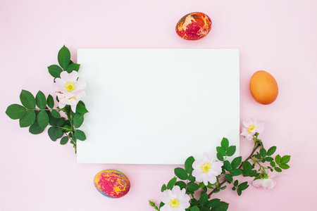 Colored eggs of branches with cherry or apricot branch with white paper for text. Easter. copy spaceの写真素材