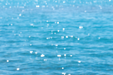 Blurred defocused blue sea with highlights and waves background. Travel, summer. copy spaceの写真素材