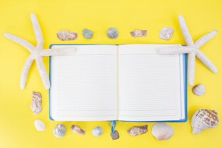Starfish, shells around open lined notepad. Summer, vacation, travel. copy spaceの写真素材