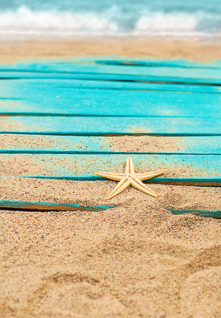 Orange starfish on blue rustic nautical wooden pier boards. Summer, sea background. Concept of travel, vacation. vertical. copy spaceの写真素材
