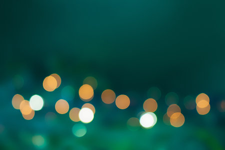 Abstract defocused lights on green blurred background. Christmas, New Year, birthday. copy spaceの写真素材