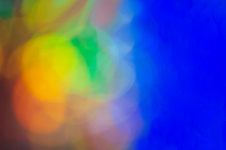 Abstract background in blue, yellow, orange neon glow colors. Background for event, party, carnival, holiday, other event. copy spaceの写真素材