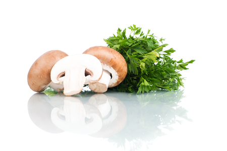 Fresh cut champignons with parsley isolated on whiteの写真素材