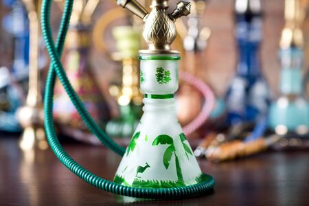 group of eastern hookahs on wood tableの写真素材